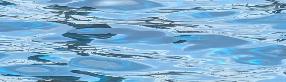 Image of blue water in a pool, rippling slightly.