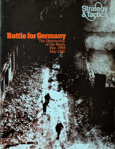 The front cover of Strategy & Tactics magazine number 50 with a dark, shadowy picture of soldiers walking through a street edged with destroyed and damaged buildings.